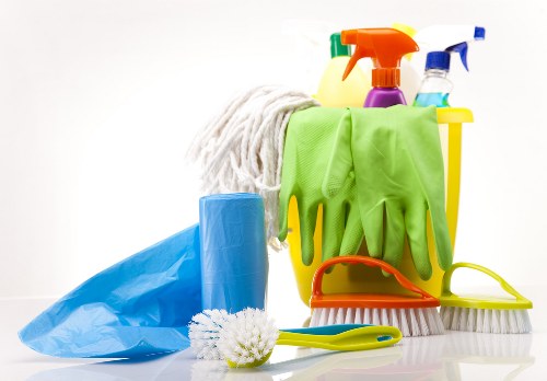 Professional office cleaning in a workspace with desks and chairs